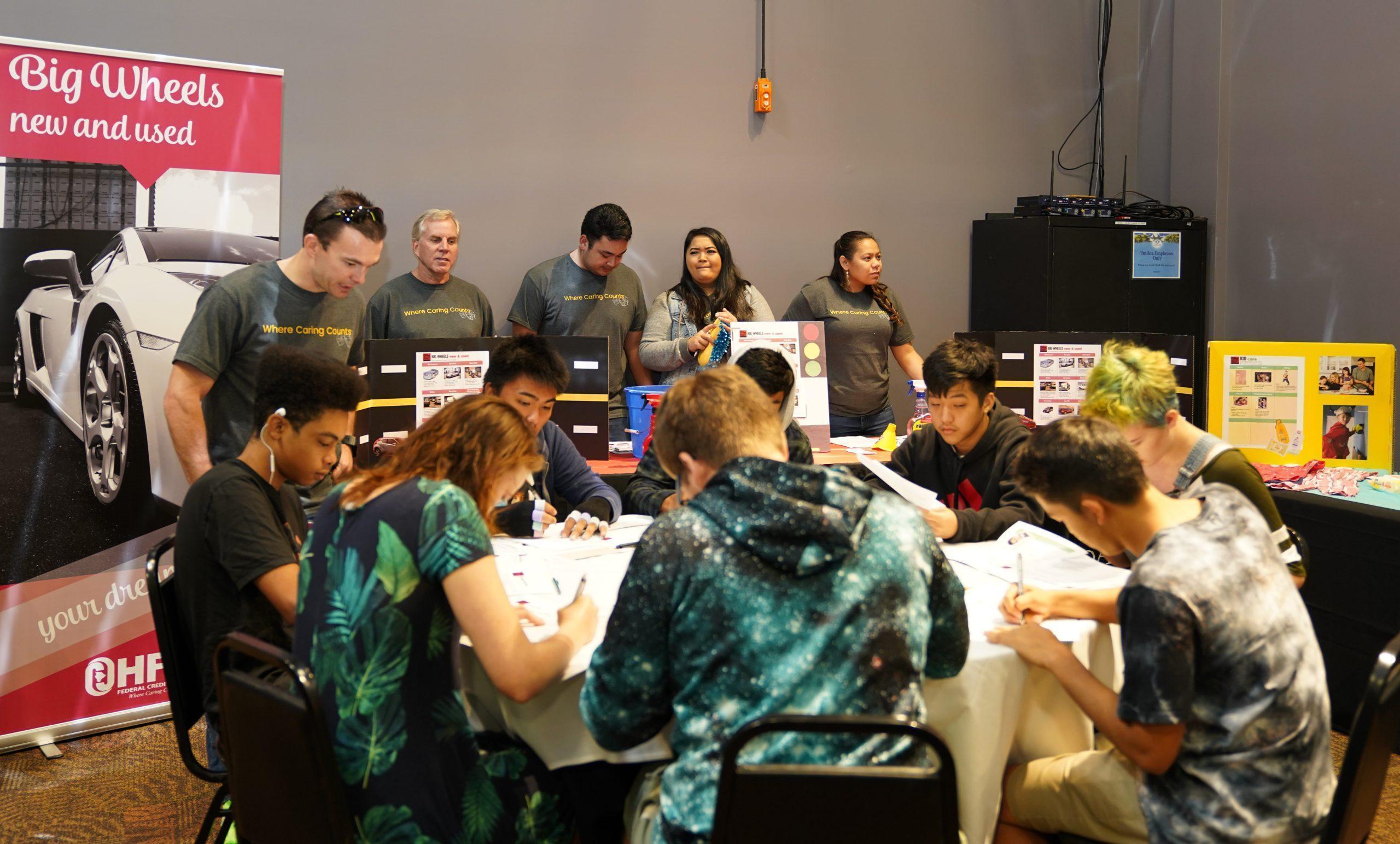 students huddle together to complete their profiles