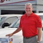 Man smiling next to Toyota truck