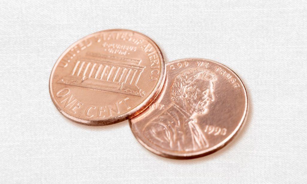 two pennies on linen surface