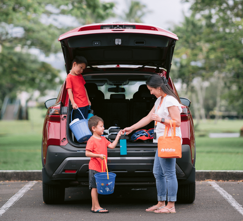 boys with mom by car in park